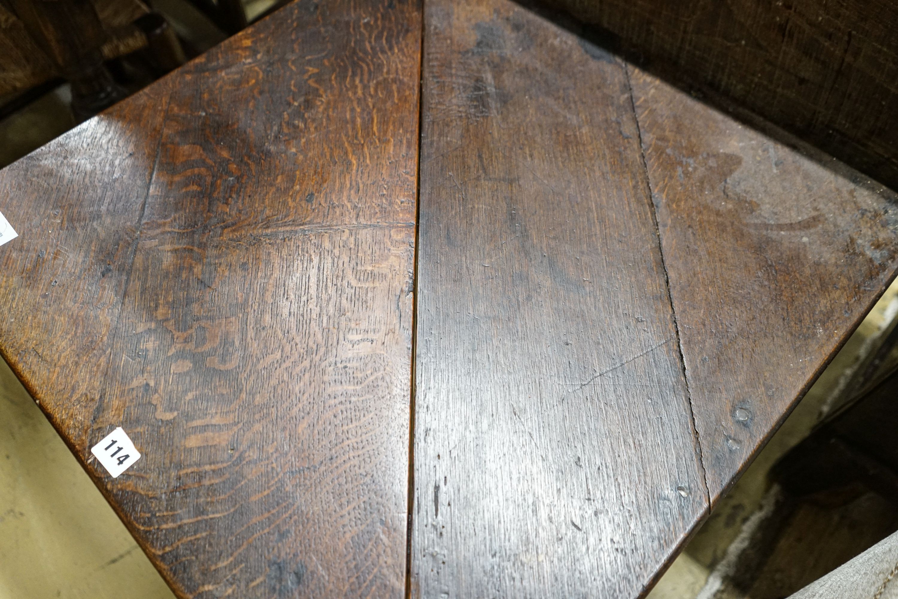 A George II oak folding top tea table, with triangular flap, on turned legs and pad feet, 64cm extended, depth 64cm, height 68cm